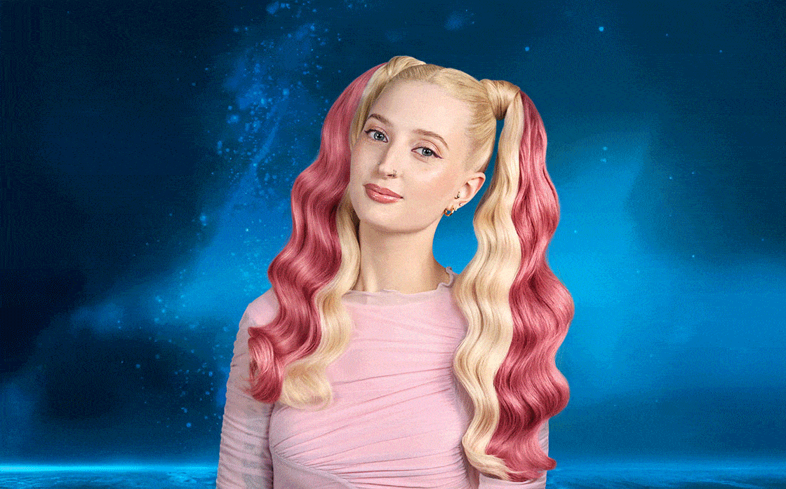 A model with pink and blonde hair on a blue background