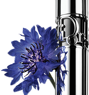 A purple flower next to a stylish mascara bottle